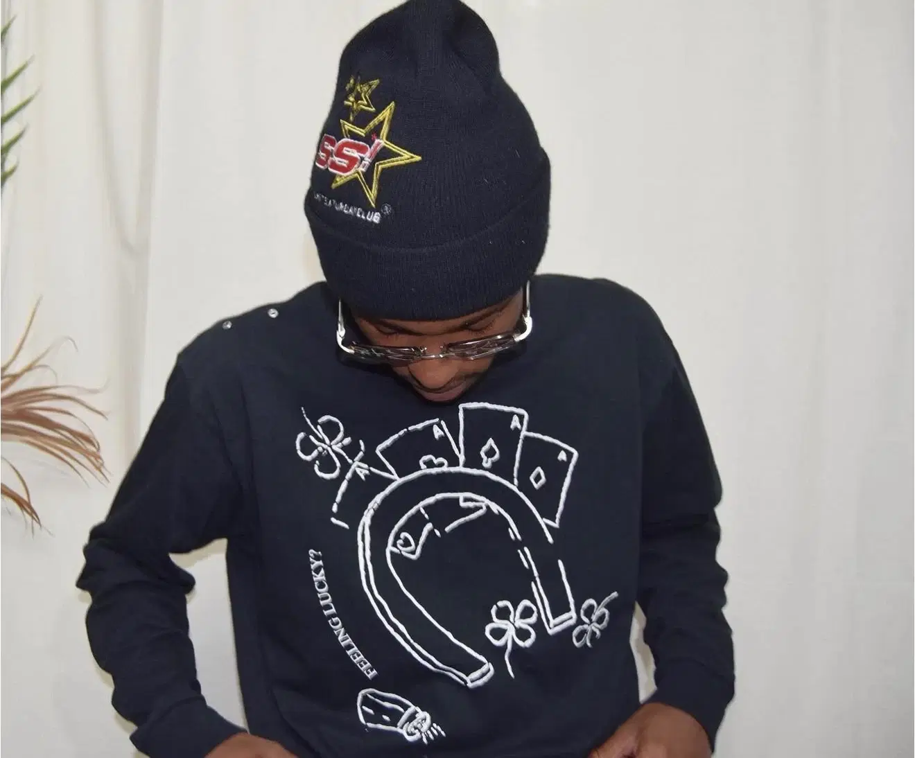Navy “Feeling Lucky” top with a playing-card and horseshoe graphic, shown being worn